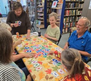 Group of senior citizens playing Uno - Red Bud Senior Link
